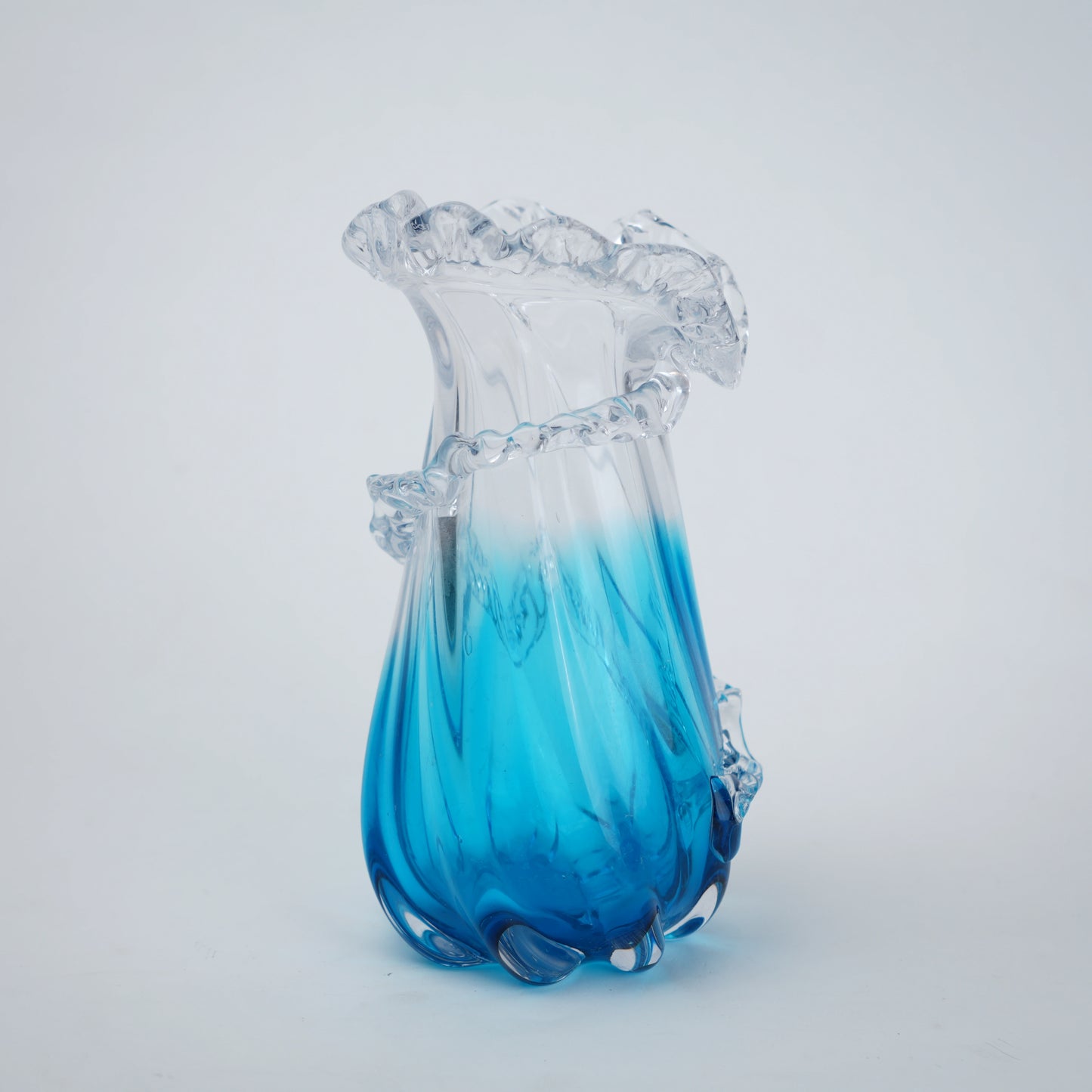 Glass vase with blue and clear design on a white background