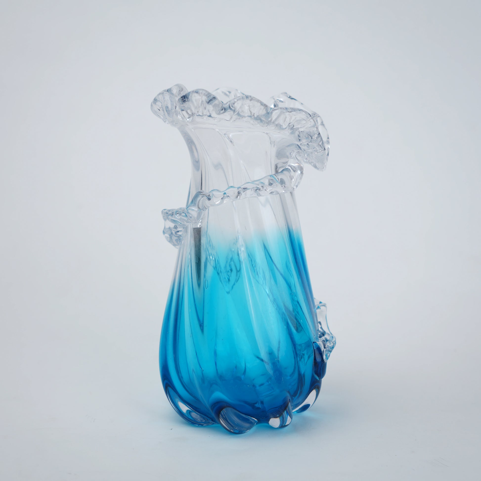 Glass vase with blue and clear design on a white background