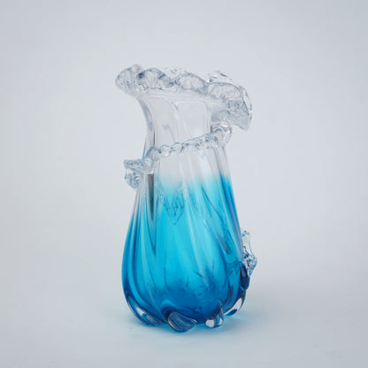 Glass vase with blue and clear design on a white background