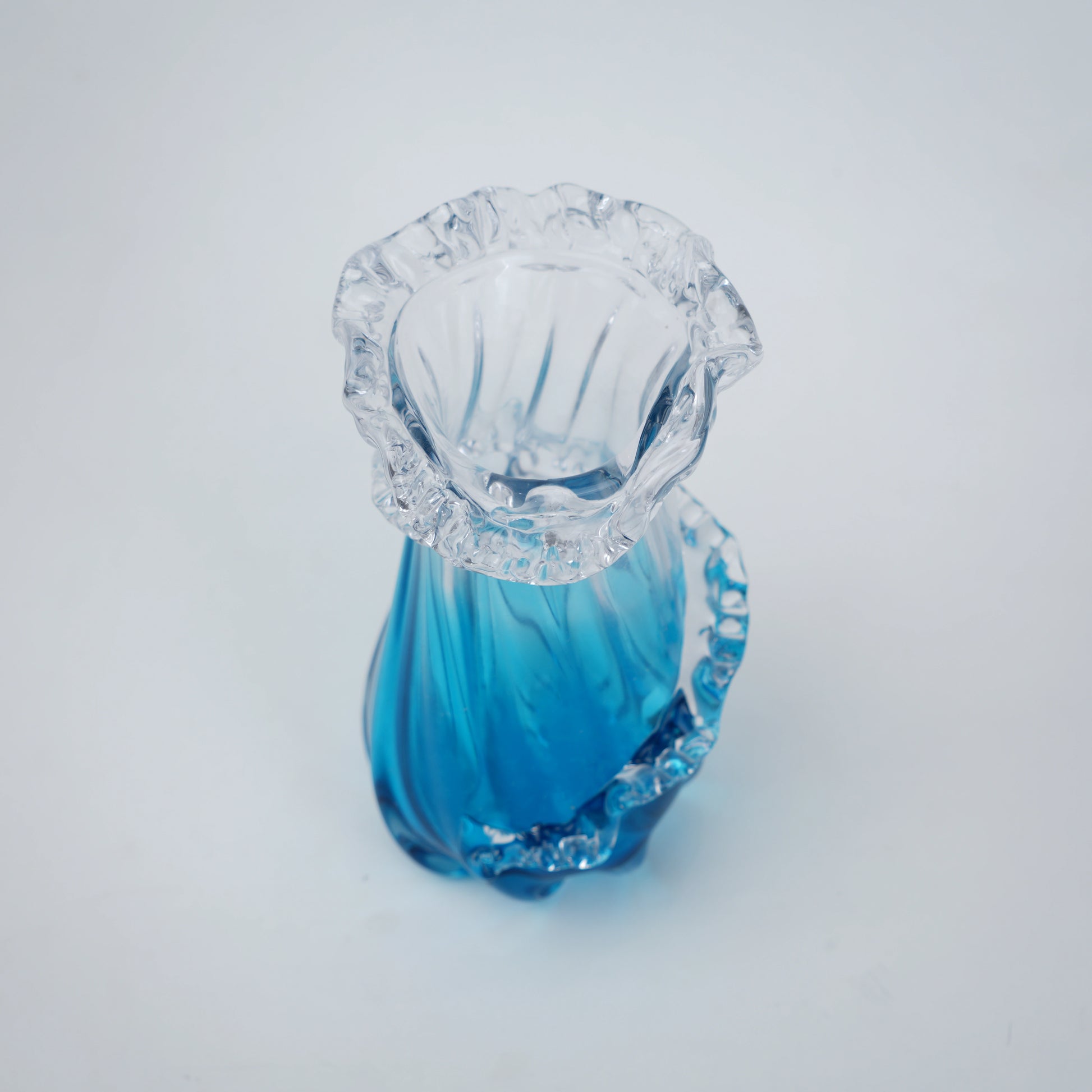 Glass vase with blue and clear design on a white background