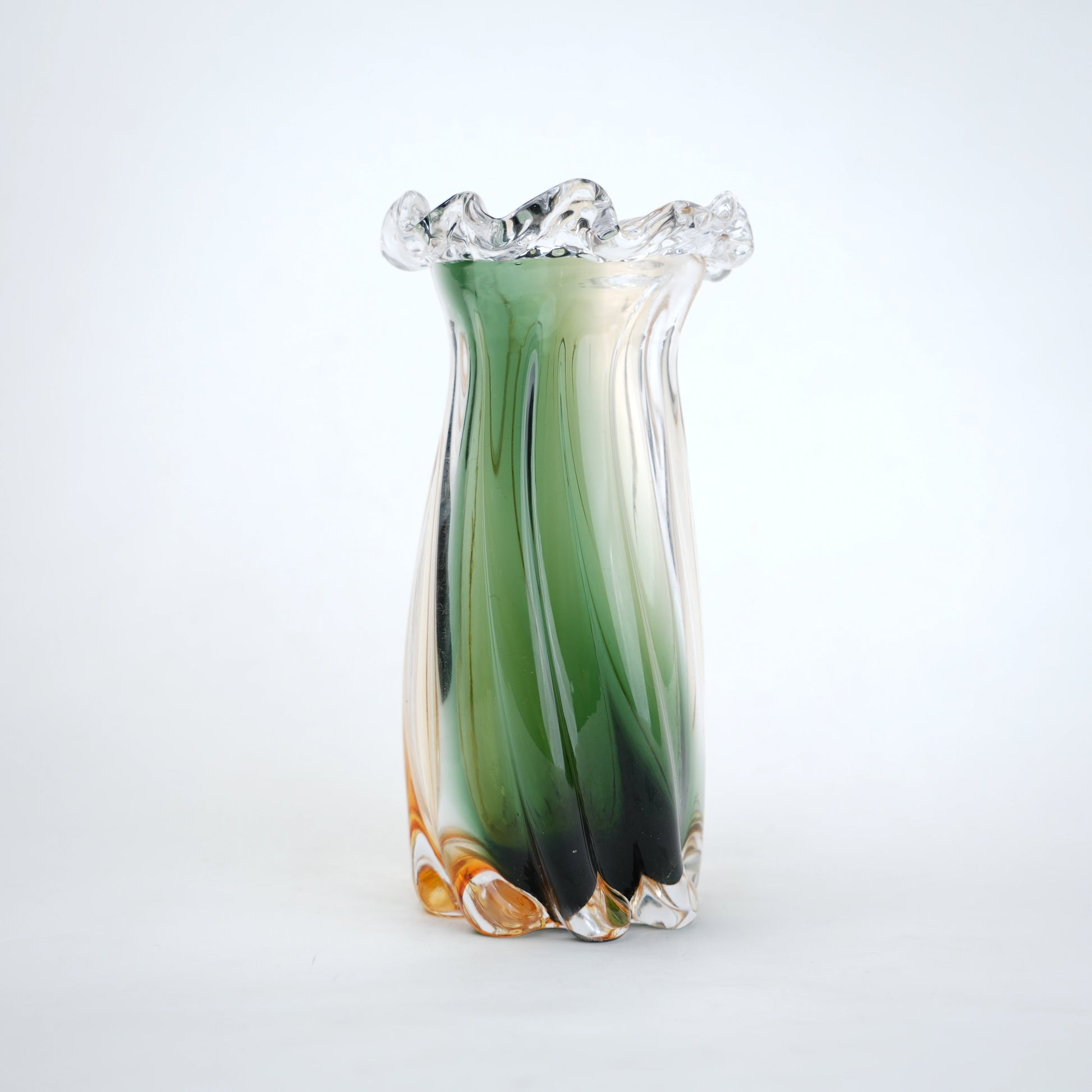 Glass vase with green and orange gradient on a white background