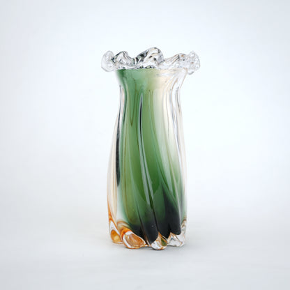 Glass vase with green and orange gradient on a white background