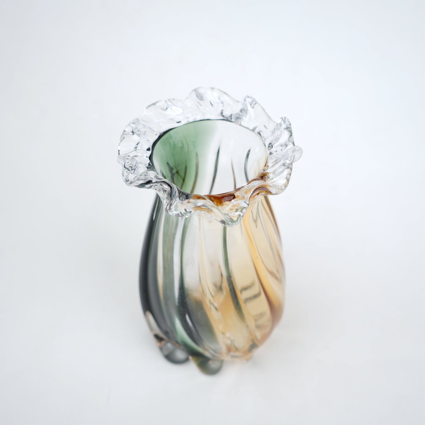 Glass vase with green and gold gradient on a white background