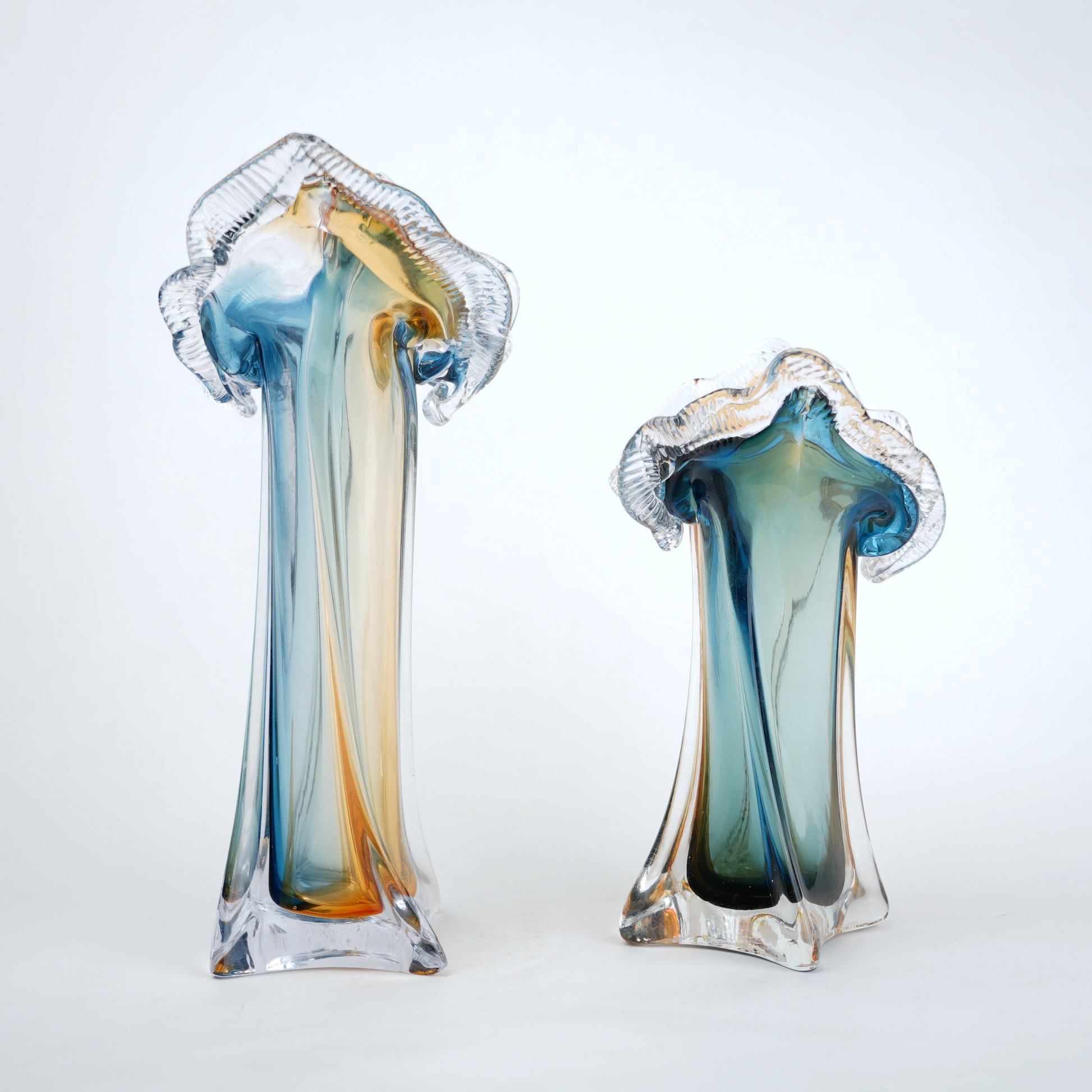 Dual tone blue and amber art glass vase with sculpted rim available in tall and small sizes