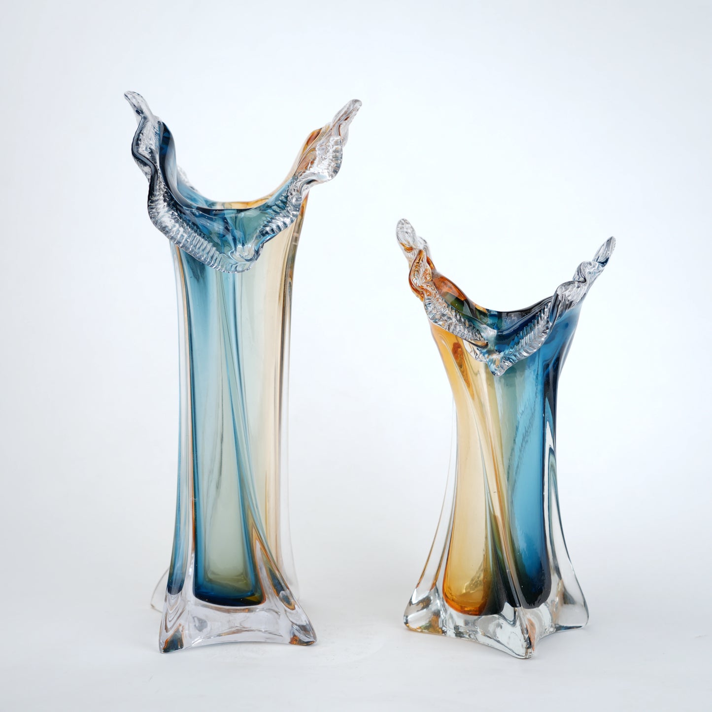 Dual tone blue and amber art glass vase with sculpted rim available in tall and small sizes