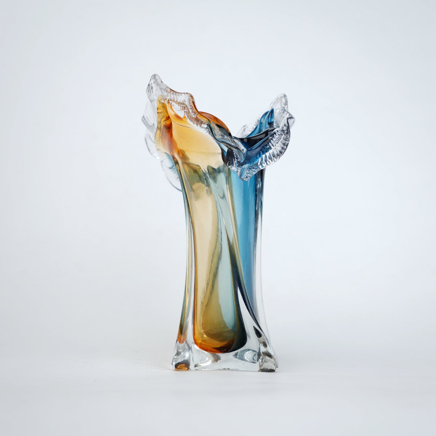 Dual tone blue and amber art glass vase with sculpted rim available in tall and small sizes
