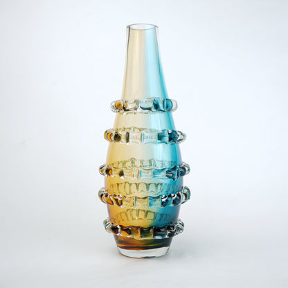 Amber and blue gradient glass vase with ribbed layered design and tall tapered shape