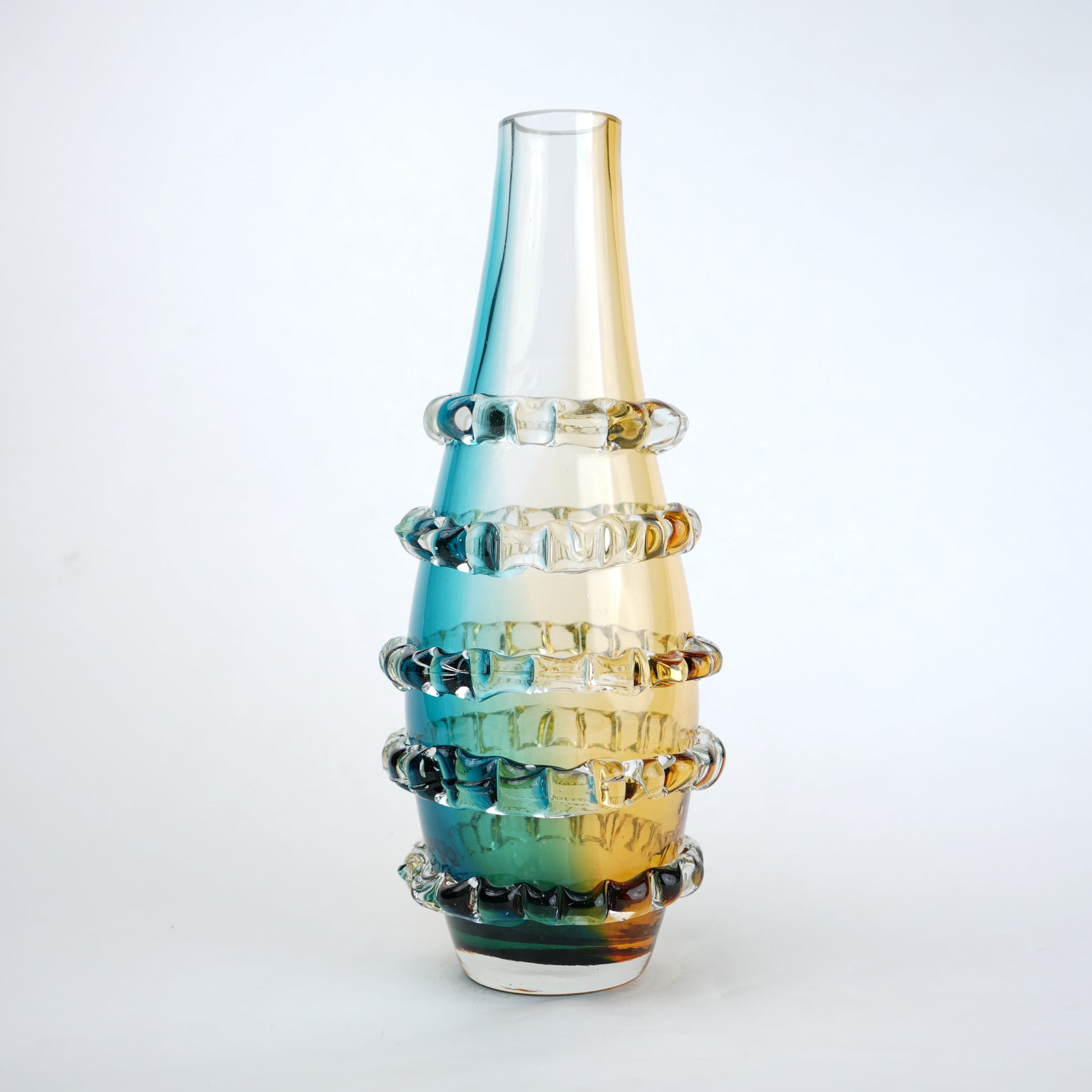 Amber and blue gradient glass vase with ribbed layered design and tall tapered shape