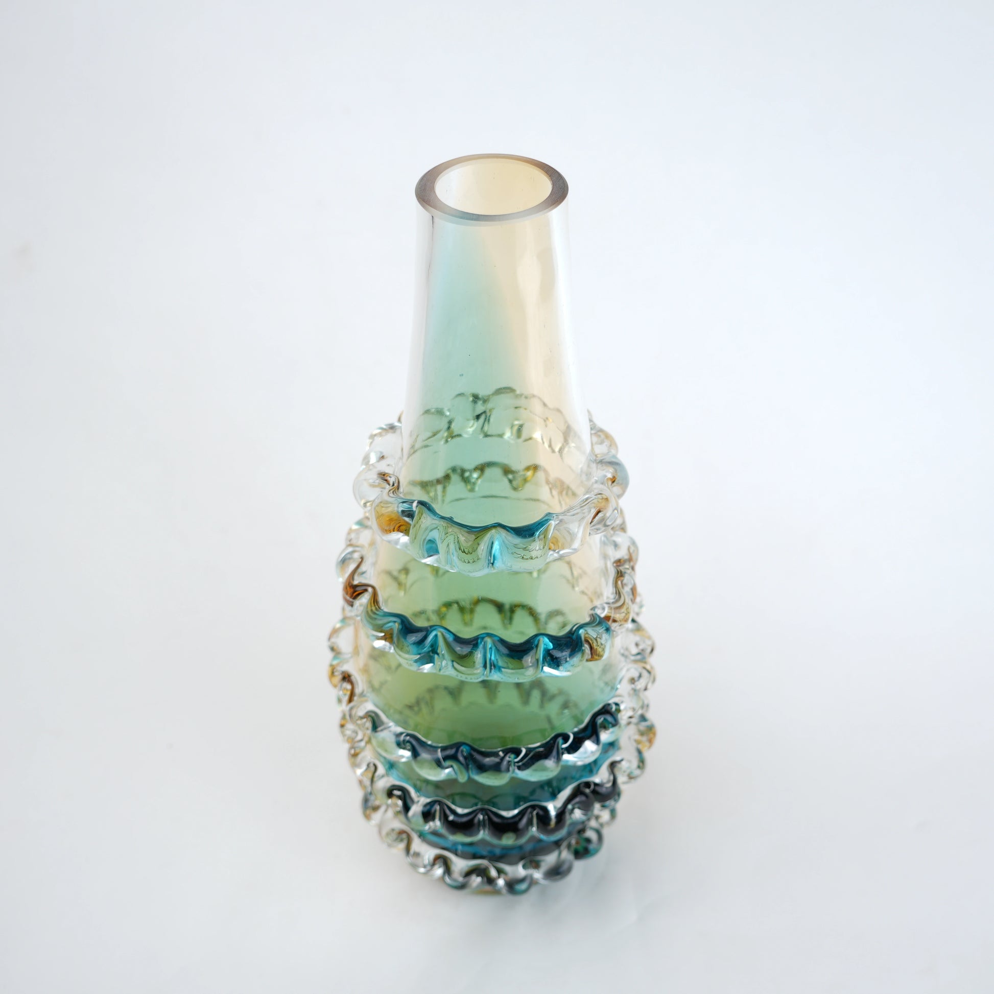 Amber and blue gradient glass vase with ribbed layered design and tall tapered shape