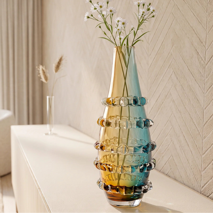 Amber and blue gradient glass vase with ribbed layered design and tall tapered shape