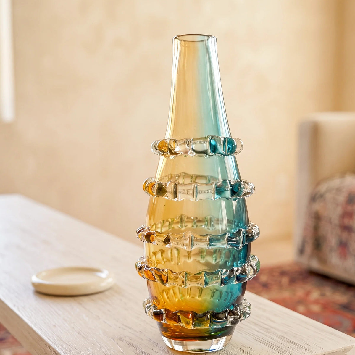 Amber and blue gradient glass vase with ribbed layered design and tall tapered shape