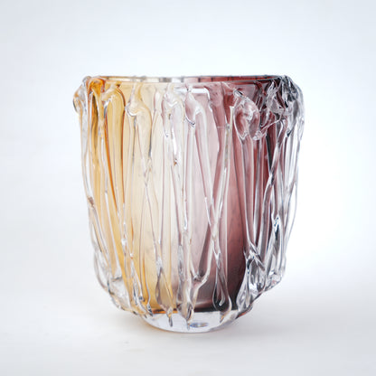 Multicolored glass vase with wavy design on a white background