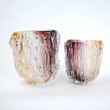 Two multicolored glass vases on a white background