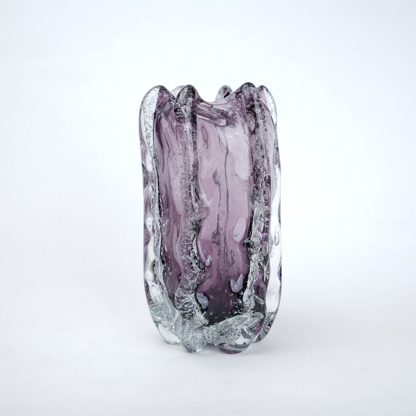 Purple glass vase with textured surface on a white background