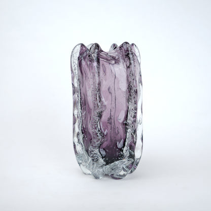 Purple glass vase with textured surface on a white background