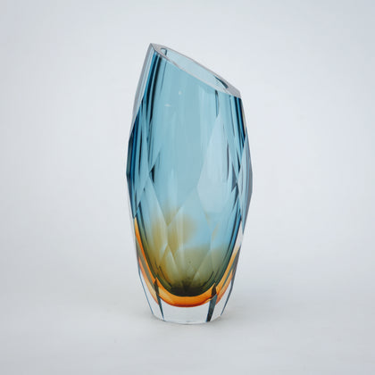 Decorative gradient glass vase with angular facets in blue and amber tones