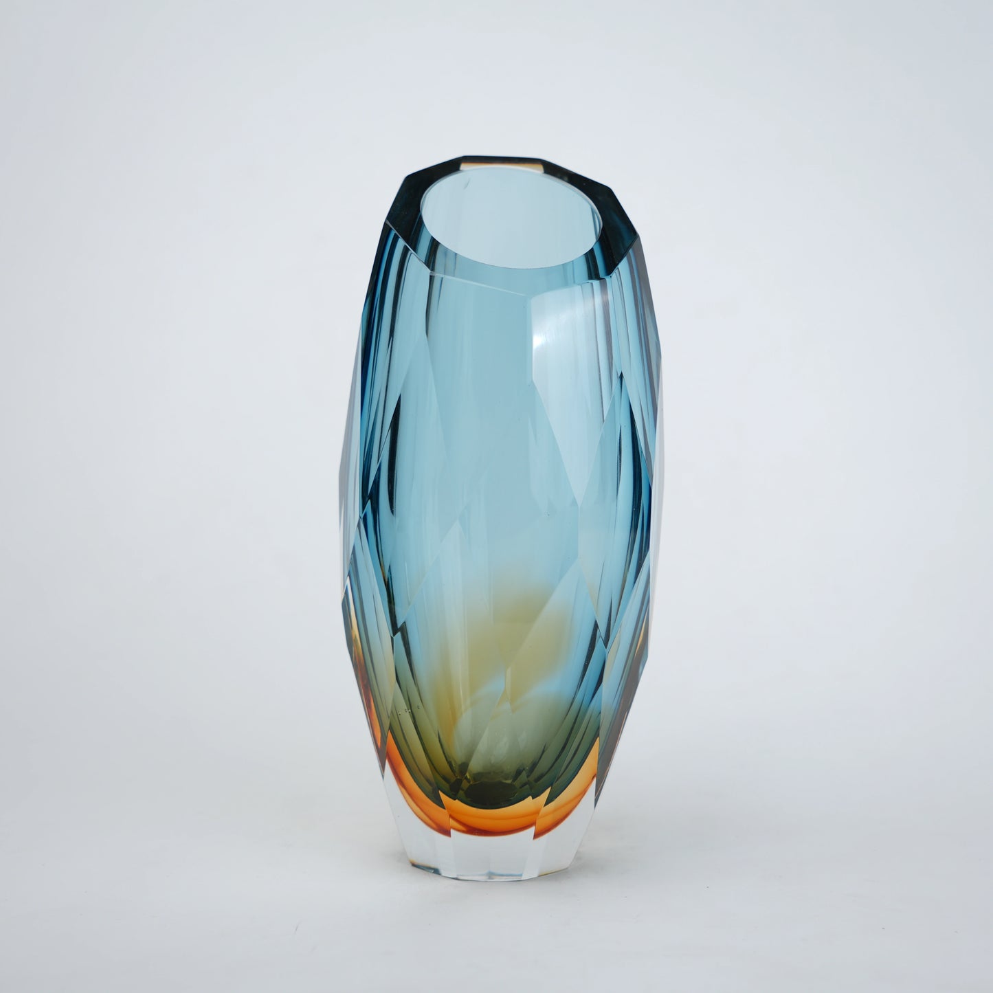 Decorative gradient glass vase with angular facets in blue and amber tones