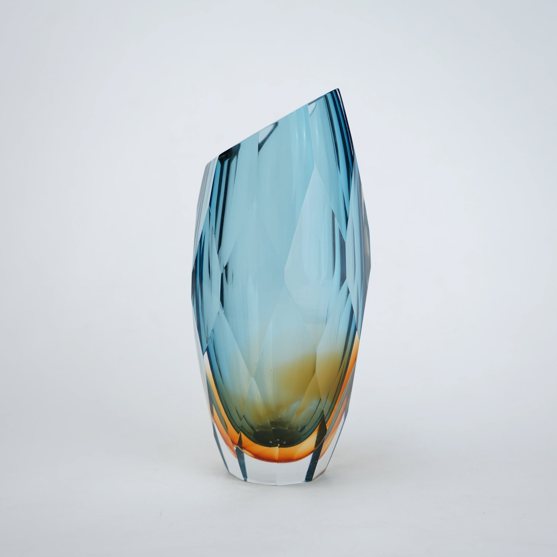Decorative gradient glass vase with angular facets in blue and amber tones