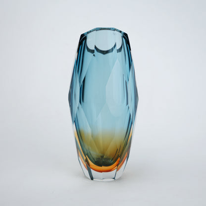 Decorative gradient glass vase with angular facets in blue and amber tones