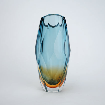 Decorative gradient glass vase with angular facets in blue and amber tones