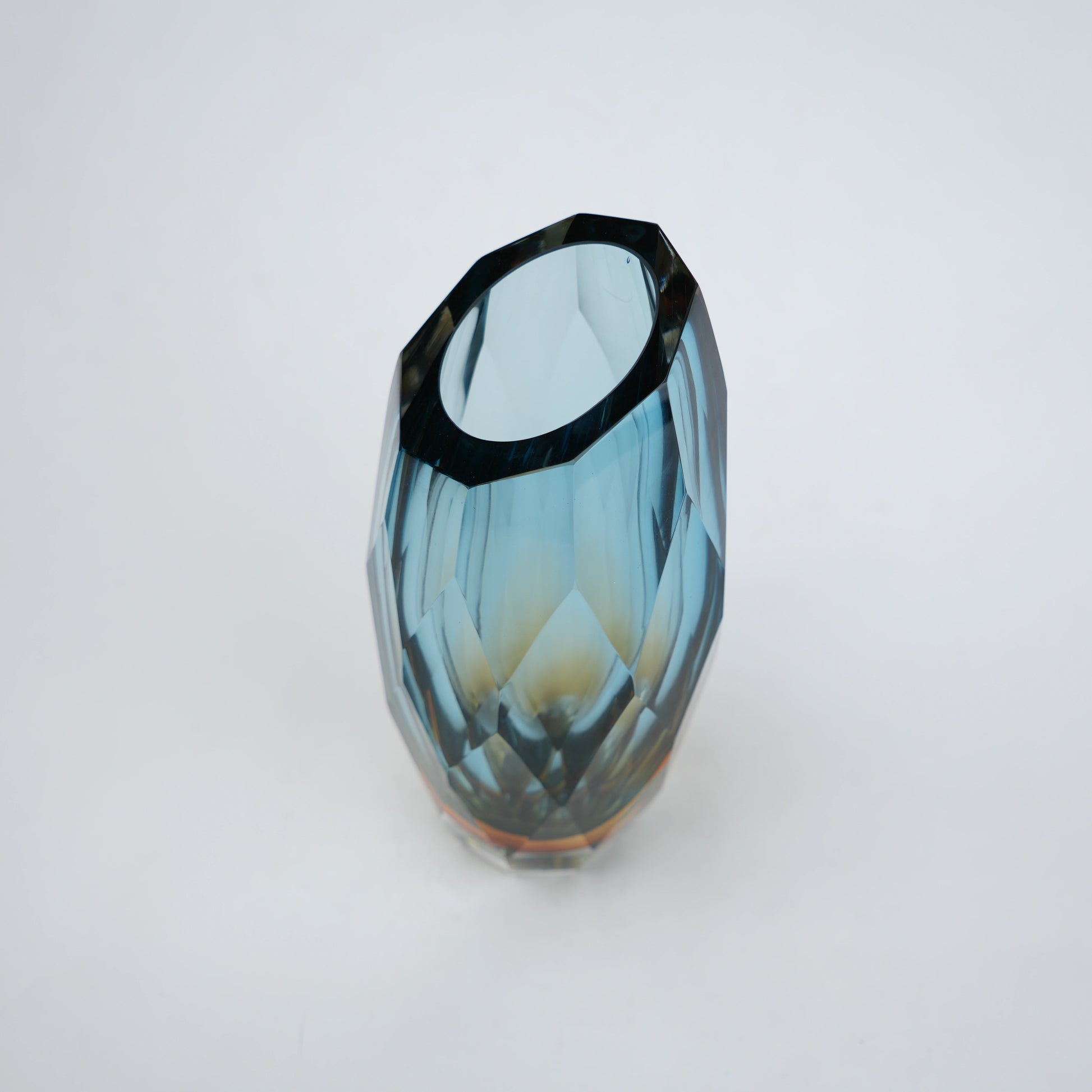 Decorative gradient glass vase with angular facets in blue and amber tones