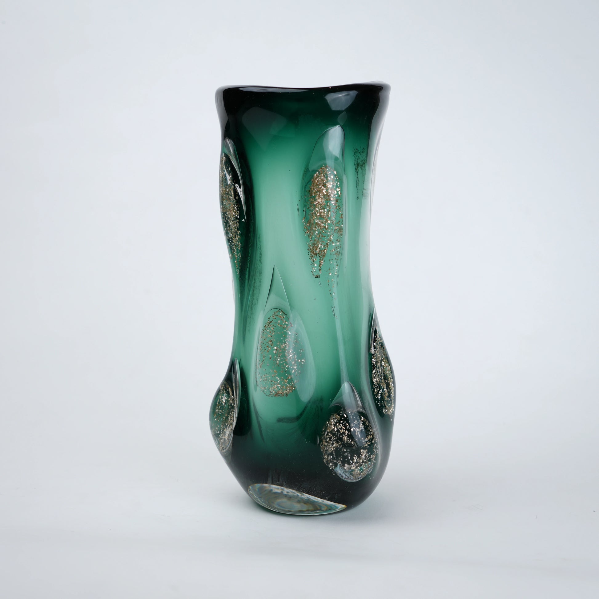Textured green glass vase with sculpted surface and embedded shimmer accents in deep emerald tone with smooth glossy finish