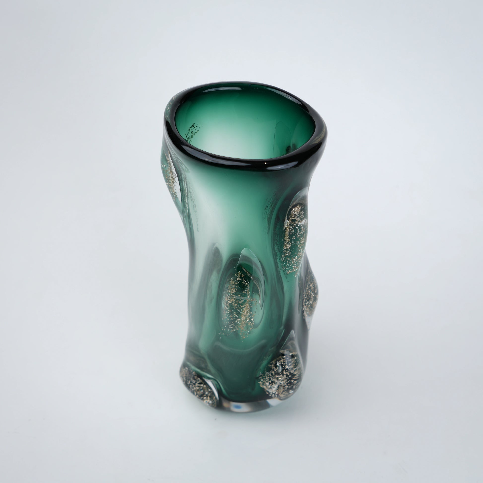 Decorative green glass vase with flared neck and dimensional textured surface featuring subtle shimmer accents in premium finish