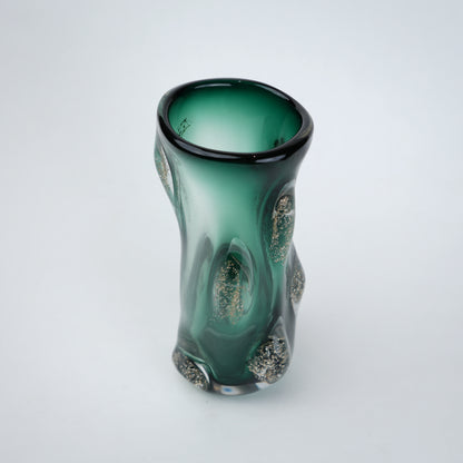 Decorative green glass vase with flared neck and dimensional textured surface featuring subtle shimmer accents in premium finish