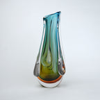 Green and teal glass vase with amber base and flowing drip design in clear glass
