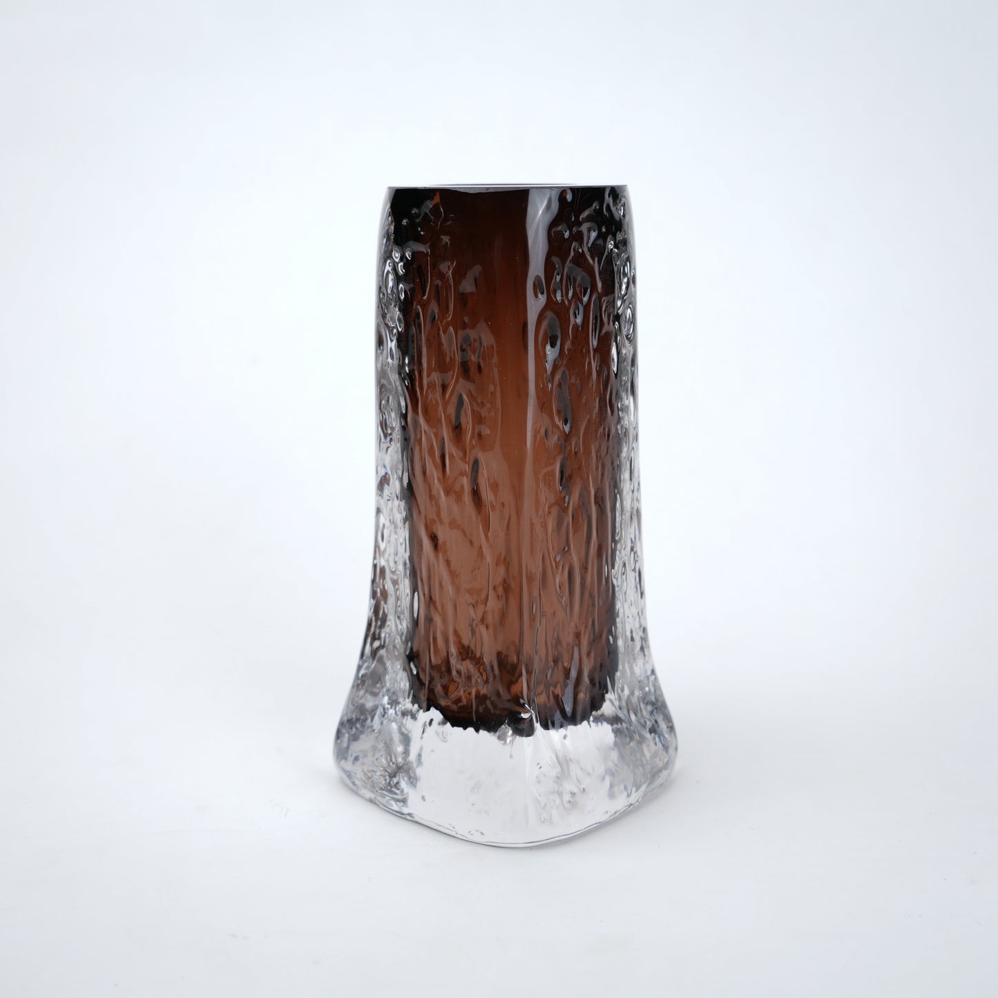 Decorative mocha glass vase featuring layered clear glass outer body and textured base with warm tone finish