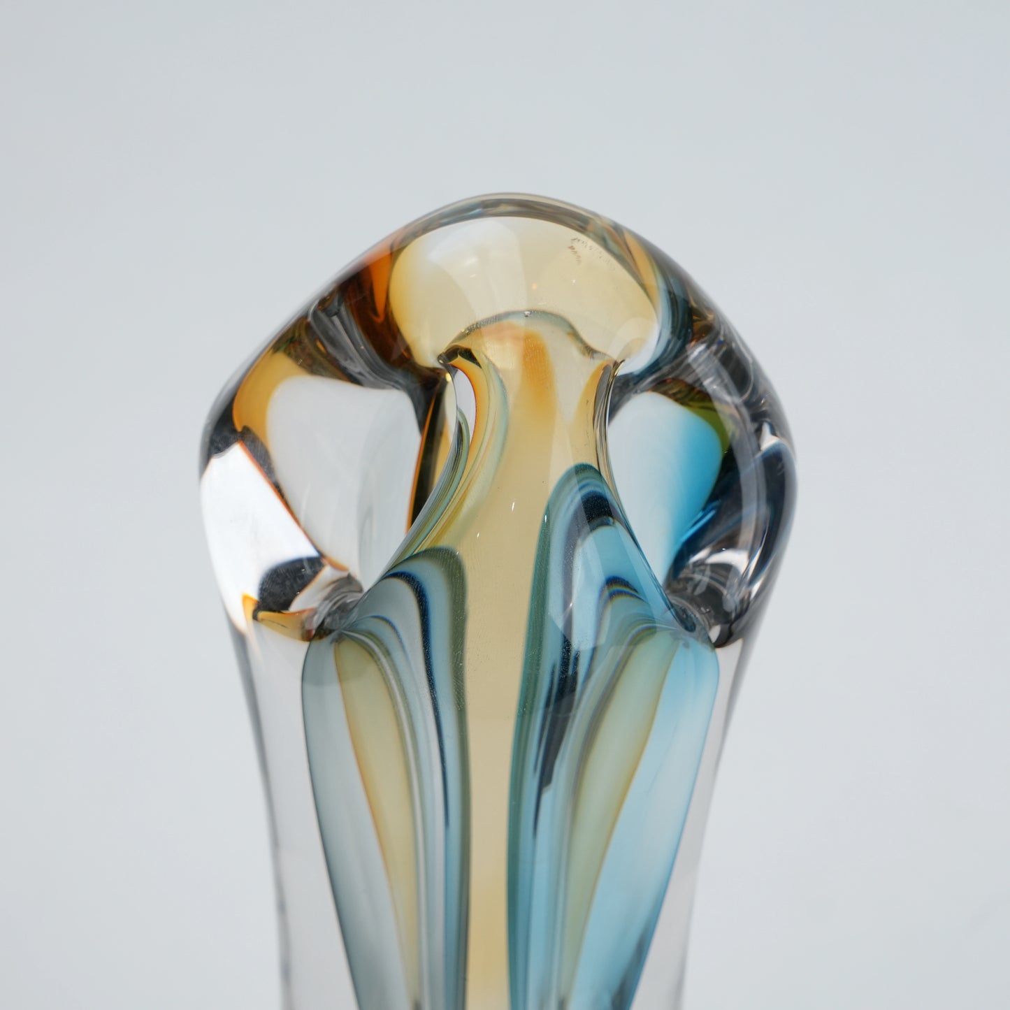 Multicolored glass vase on a light gray background