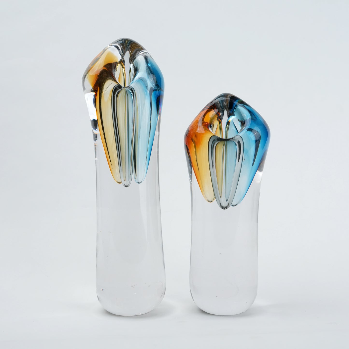 Two glass vases with multicolored tops