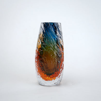 Blue and amber glass vase with textured clear outer layer and cylindrical design