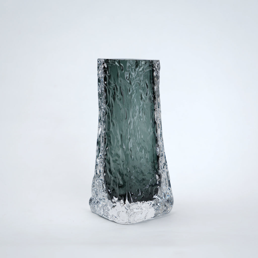 Tall, textured glass vase on a white background