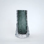 Tall, textured glass vase on a white background