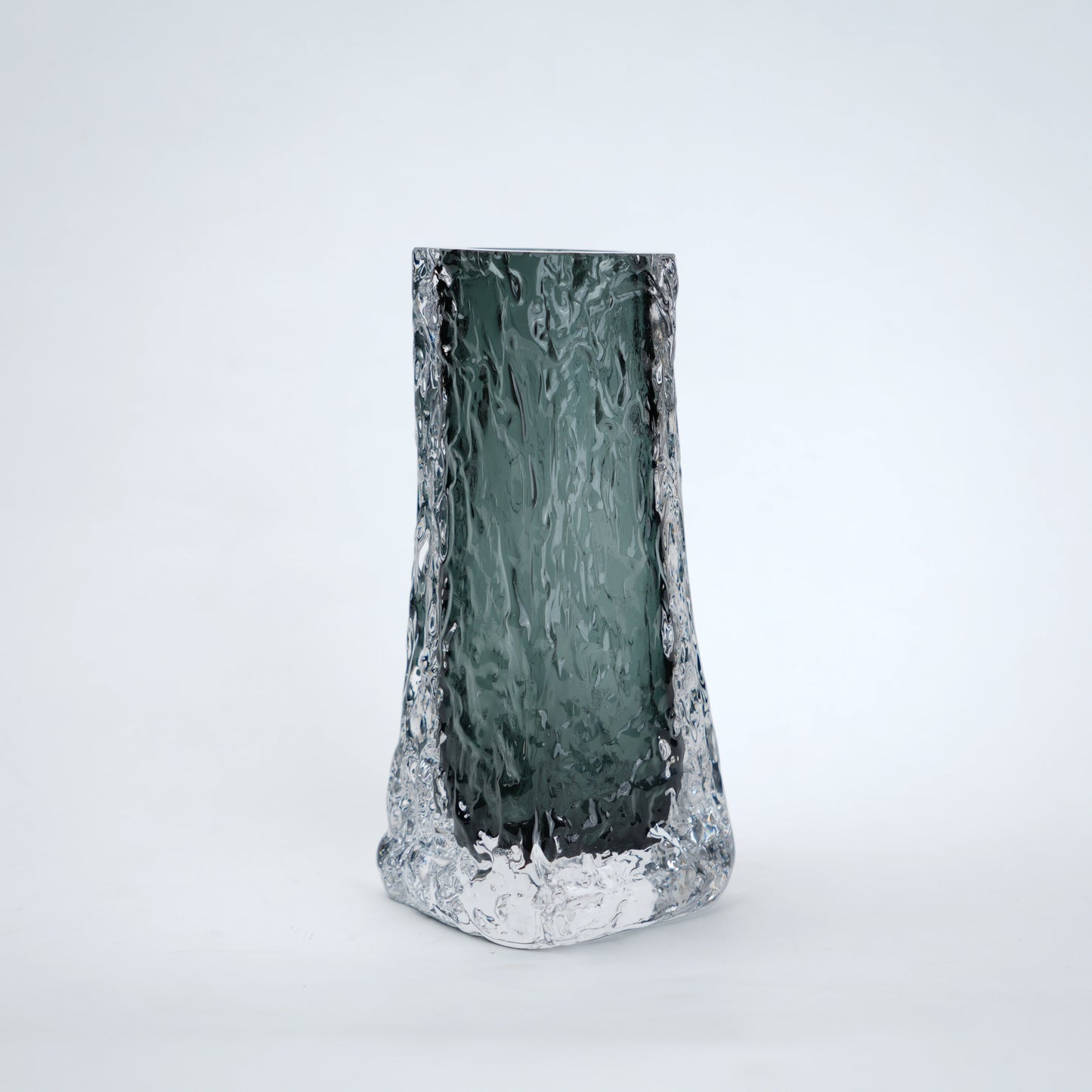 Tall, textured glass vase on a white background