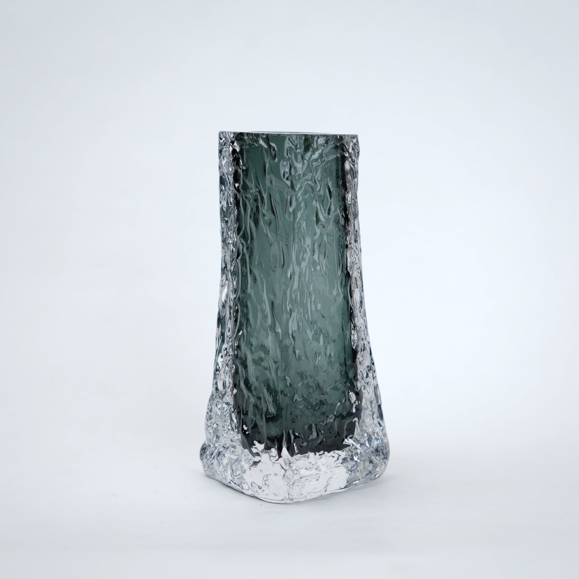 Tall, textured glass vase on a white background