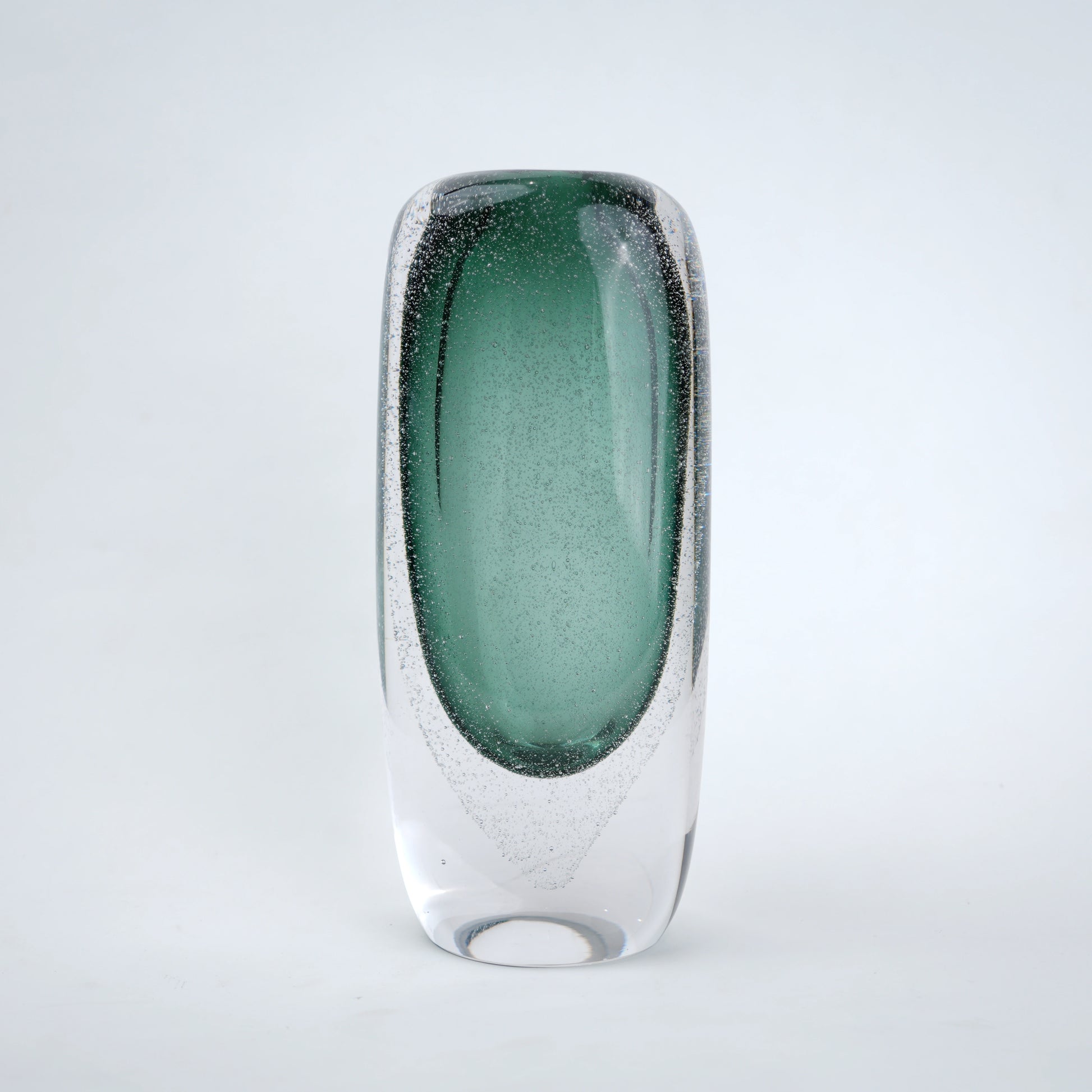 Decorative art glass vase with green gradient center encased inside clear glass body.