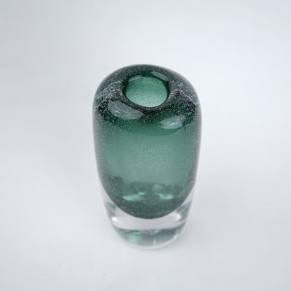 Decorative art glass vase with green gradient center encased inside clear glass body.