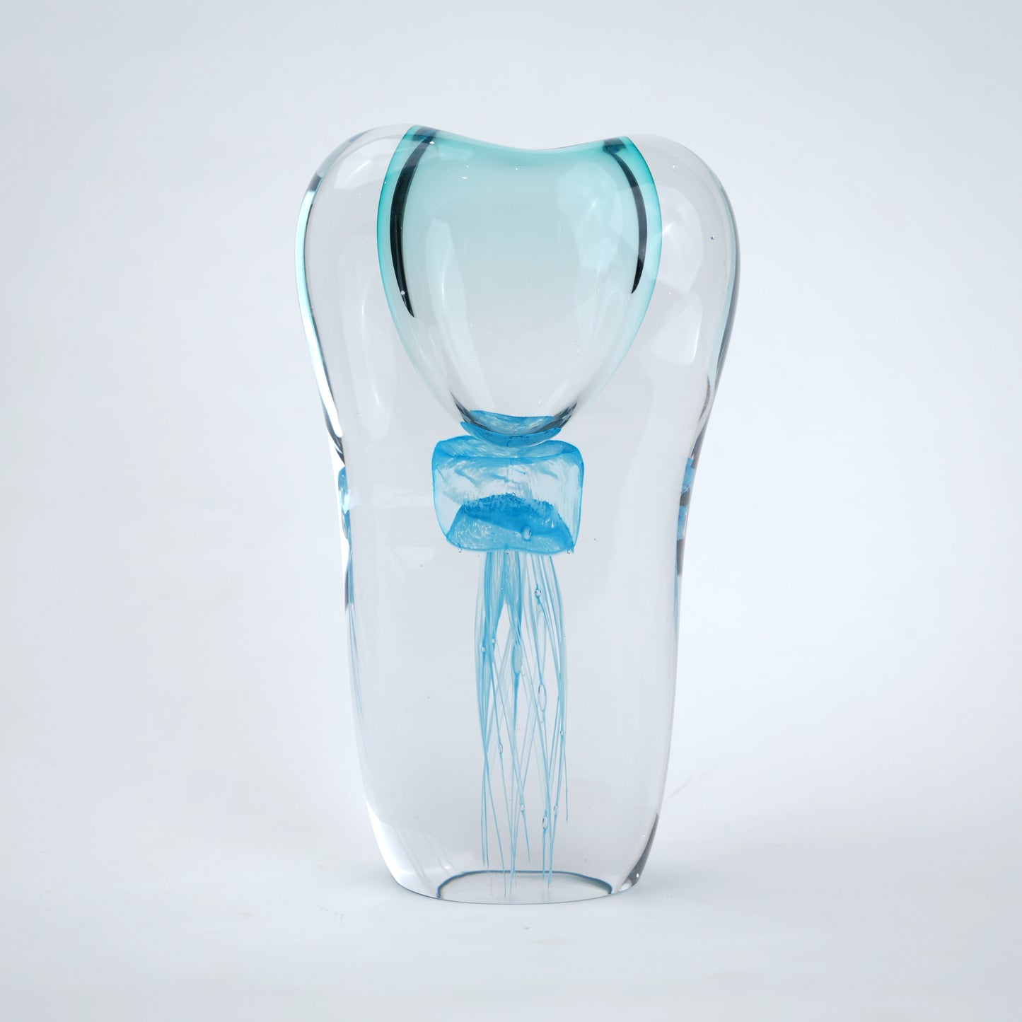 Decorative art glass vase with blue center encased inside clear glass body.