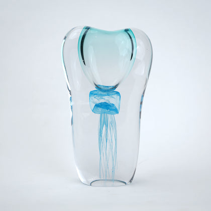 Decorative art glass vase with blue center encased inside clear glass body.