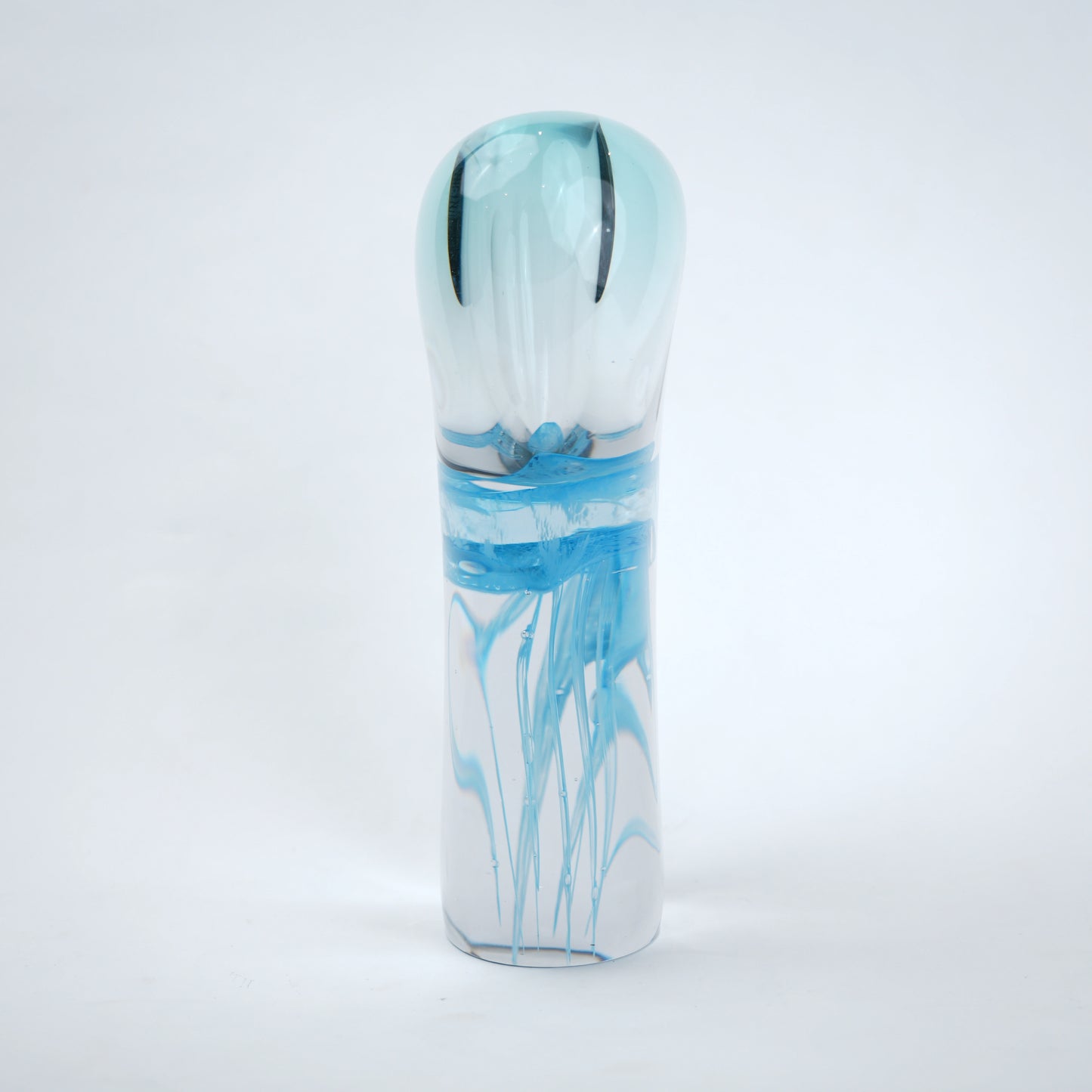 Decorative art glass vase with blue center encased inside clear glass body.