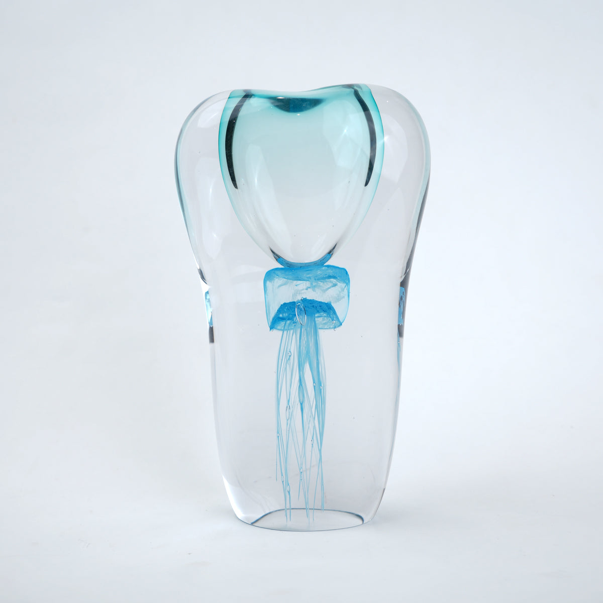 Decorative art glass vase with blue center encased inside clear glass body.