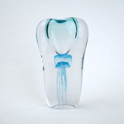 Decorative art glass vase with blue center encased inside clear glass body.