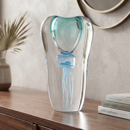 Decorative art glass vase with blue center encased inside clear glass body.