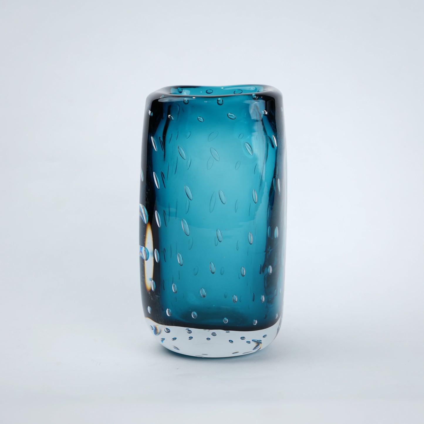 Textured blue art glass decorative vase with cylindrical form and patterned glass surface.