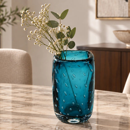 Textured blue art glass decorative vase with cylindrical form and patterned glass surface.