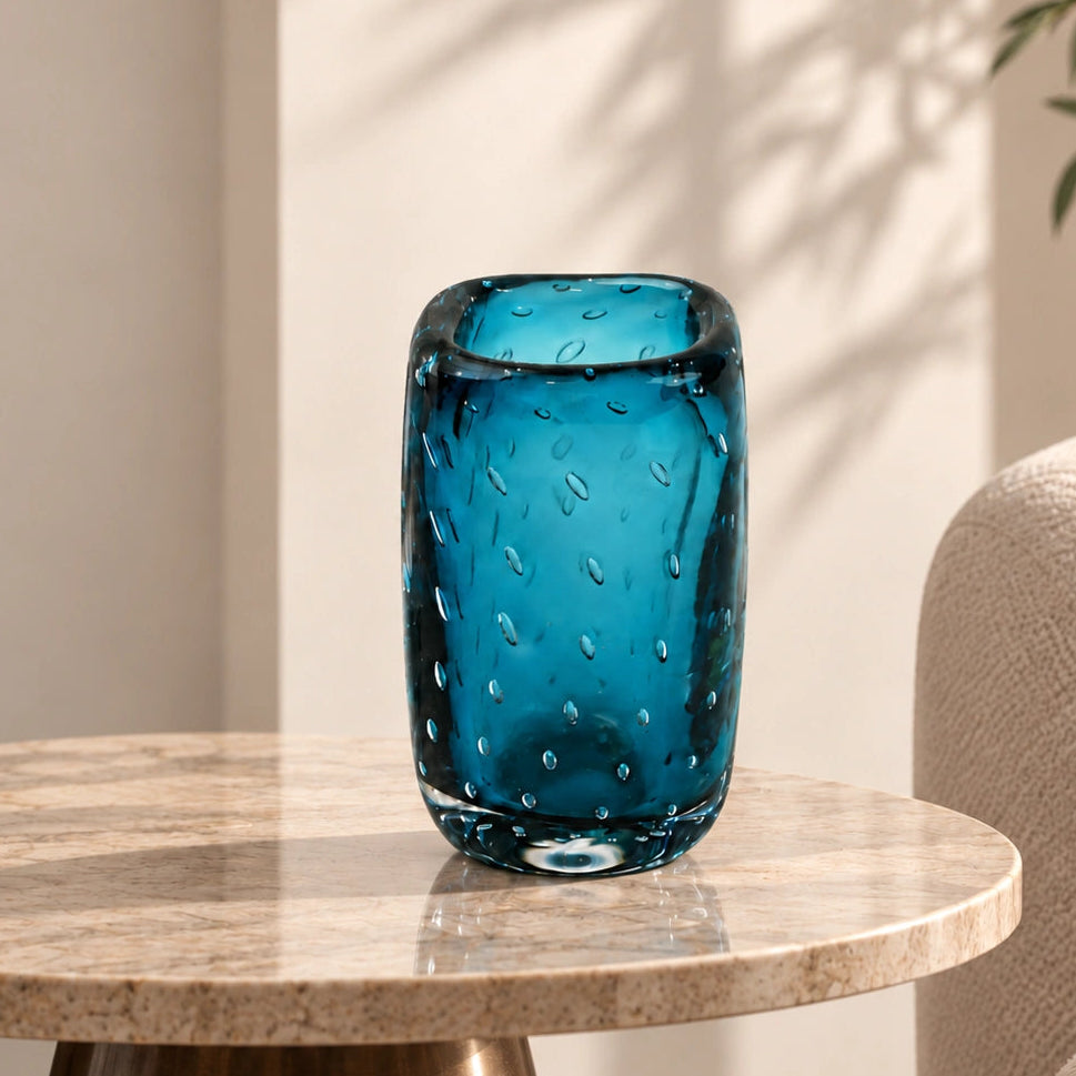 Textured blue art glass decorative vase with cylindrical form and patterned glass surface.