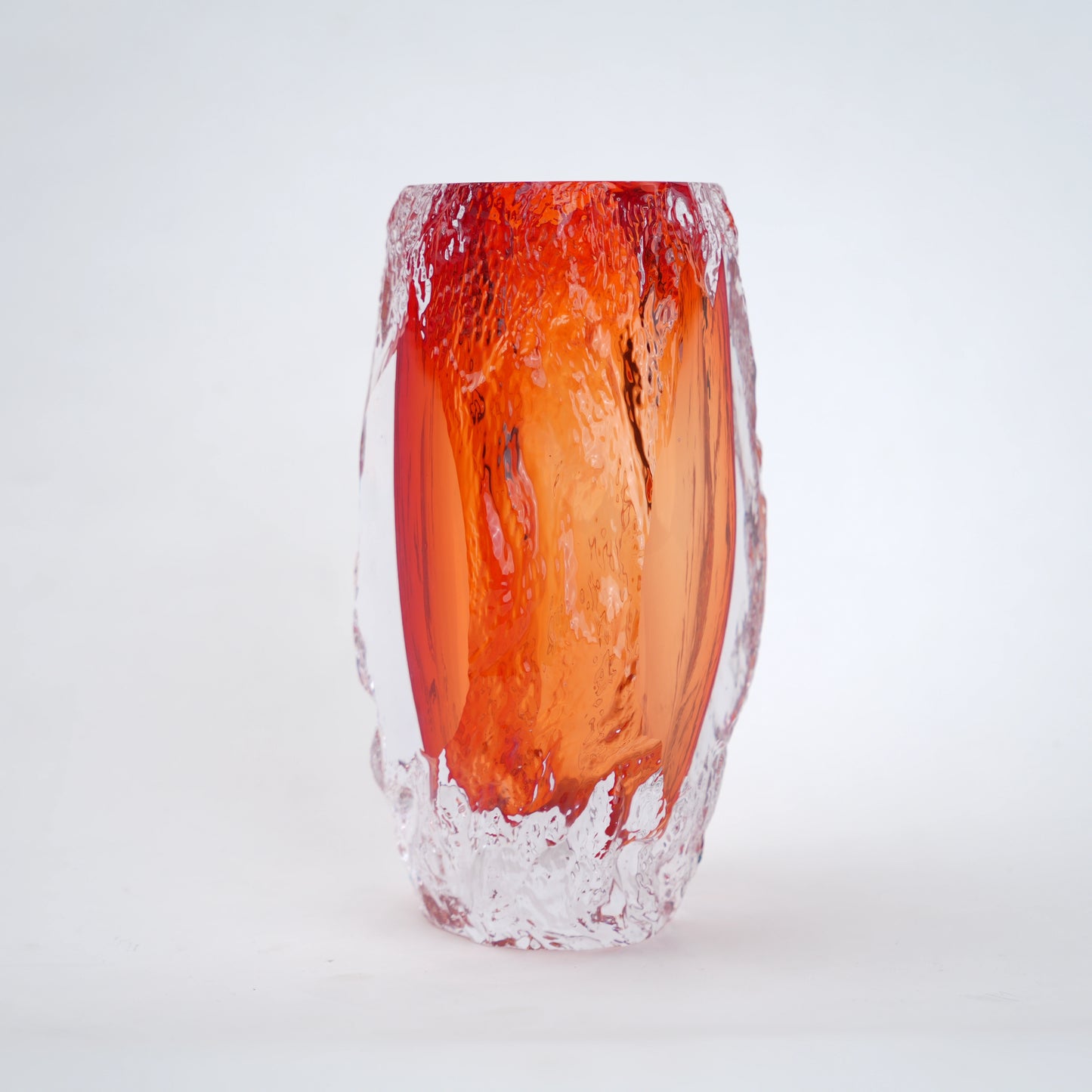 Glass vase with red and clear design on a white background