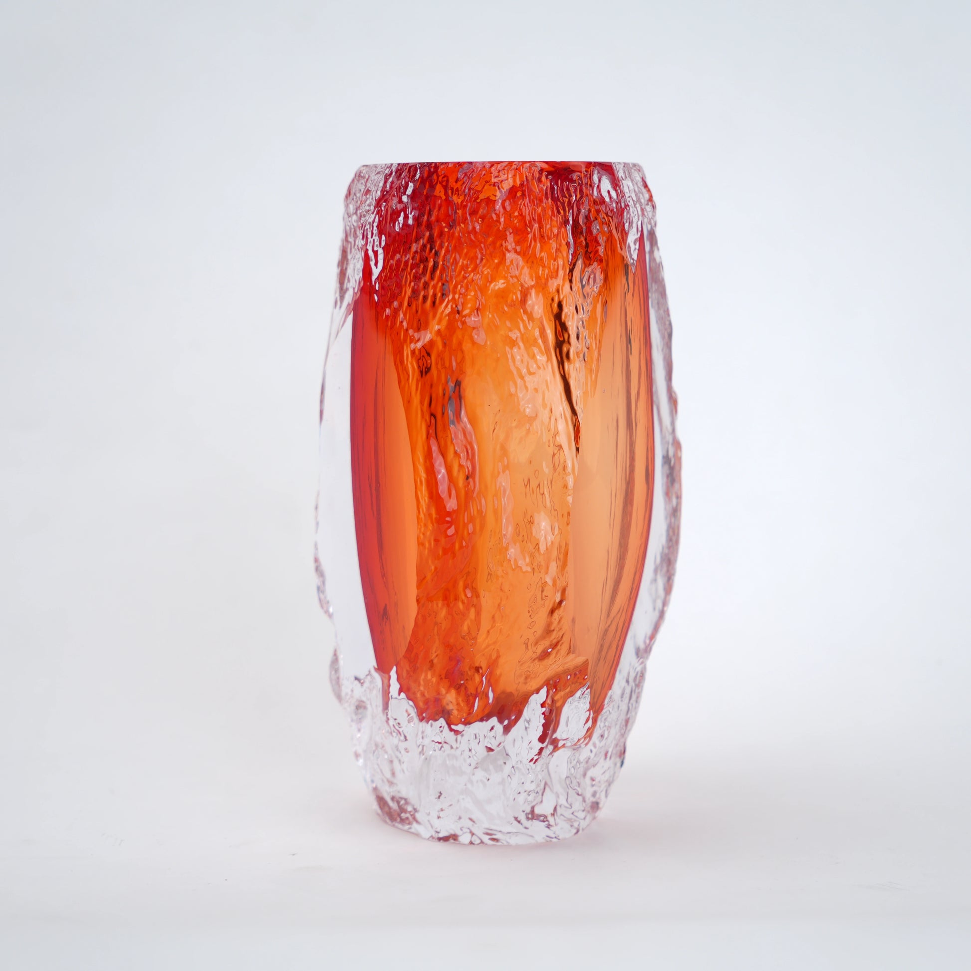 Glass vase with red and clear design on a white background